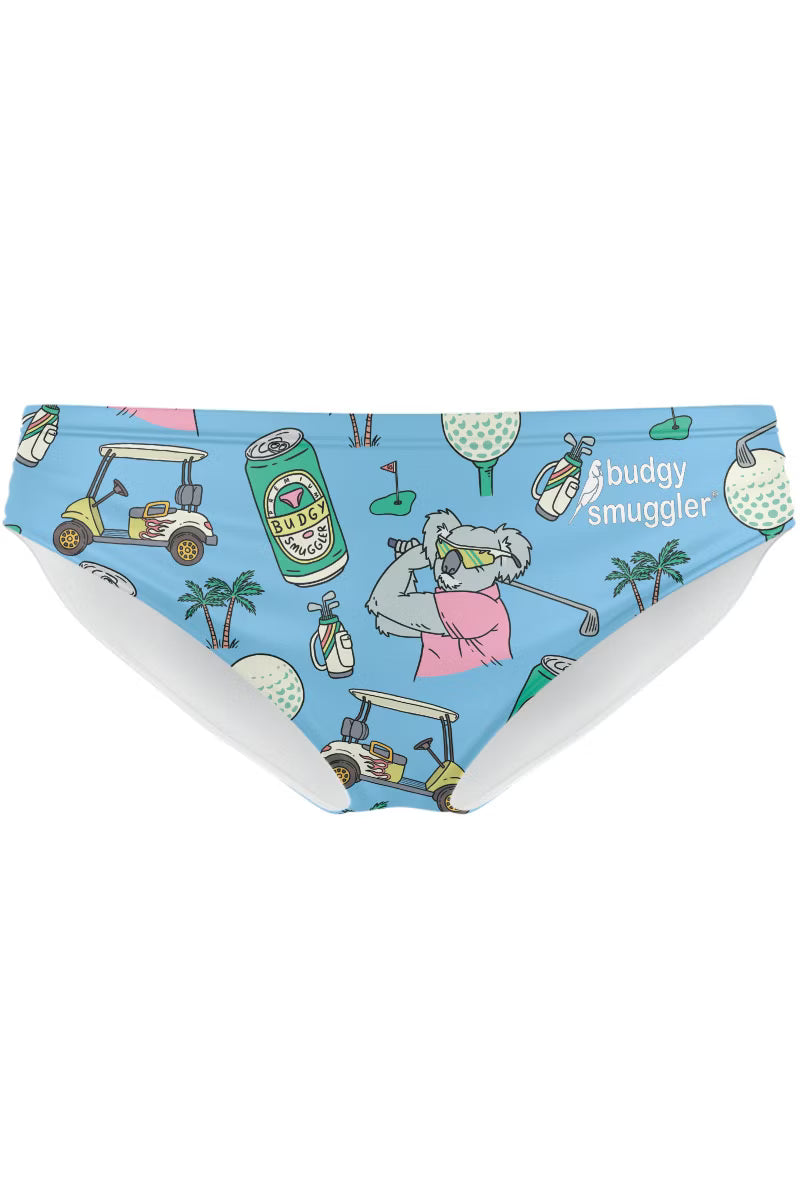 Light blue bikini bottoms featuring a golf-themed cartoon print with a koala golfer, golf carts, golf balls, palm trees, and the text 'buddy smuggler'.