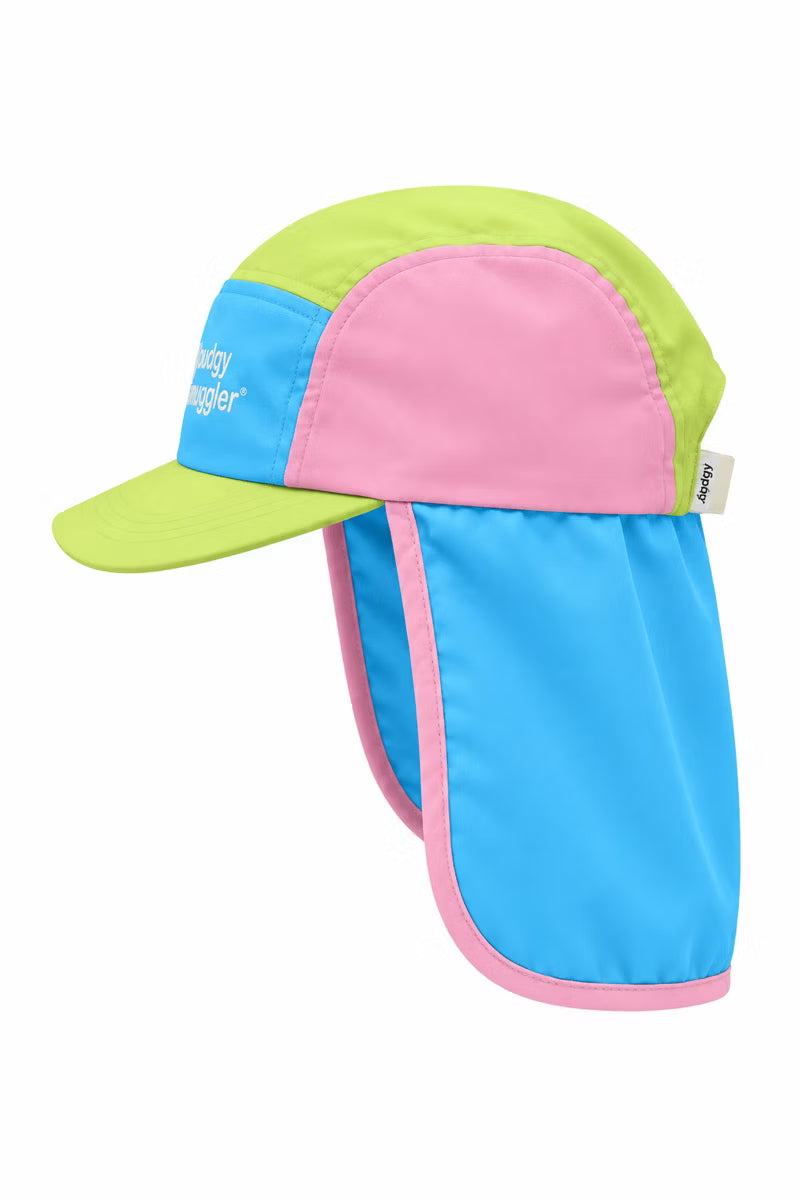 Pink green and blue hat with a neck flap on a white wall 