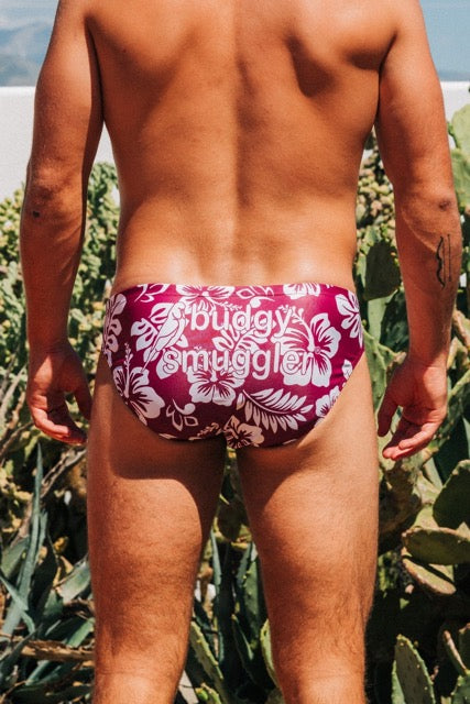Person wearing a red swimsuit with white floral pattern in a natural setting