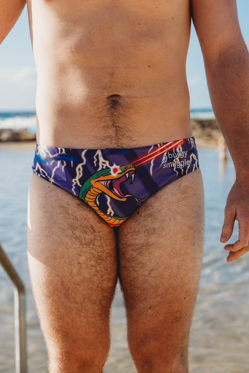 Person wearing a colorful swimsuit with a beach background