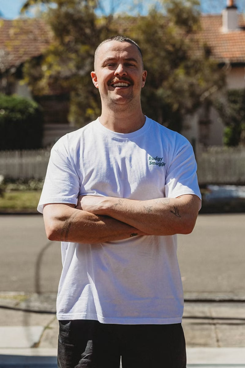 white tee shirt with green detailing on man