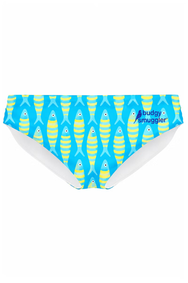 A pair of women's bikini bottoms featuring a repeating pattern of yellow and blue striped fish on a bright blue background, with a small 'Buddy Smuggler' logo printed on the right side.