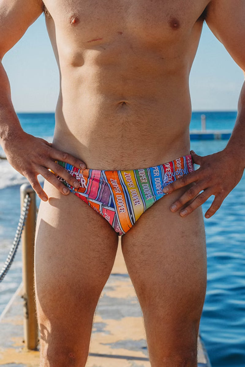 Front view of Zooper Dooper men's swimwear worn by the ocean